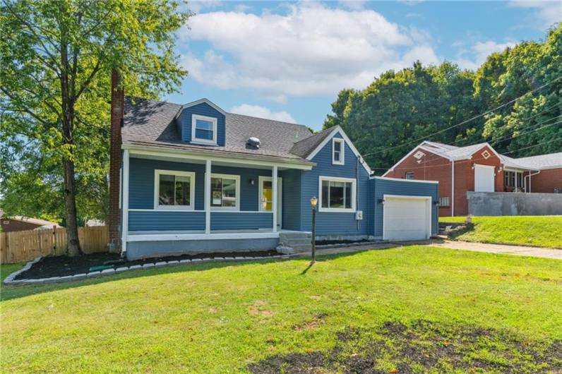 This charming Cape Cod home features a stylish rustic industrial decor, blending cozy charm with modern flair.