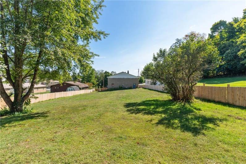 A two car garage sits at the back of the spacious yard.