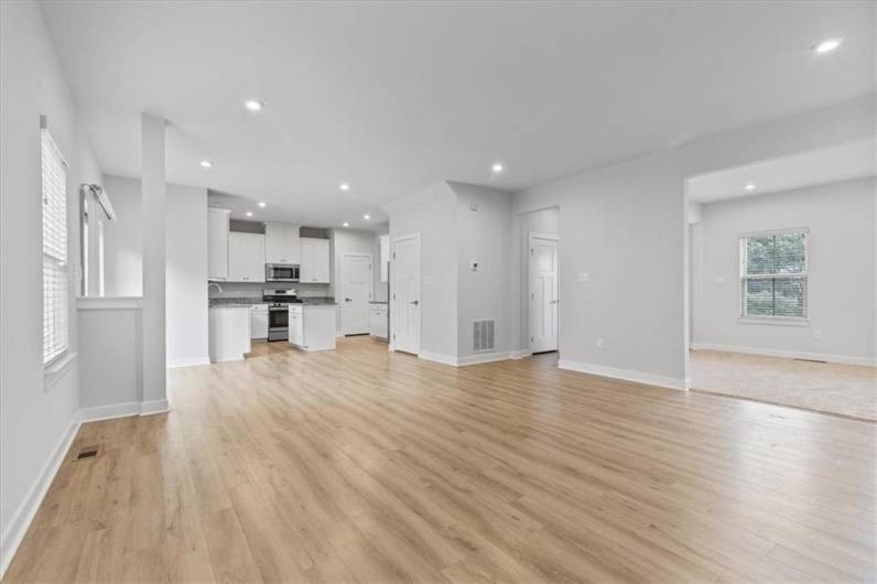 Looking from family room into kitchen and dining room