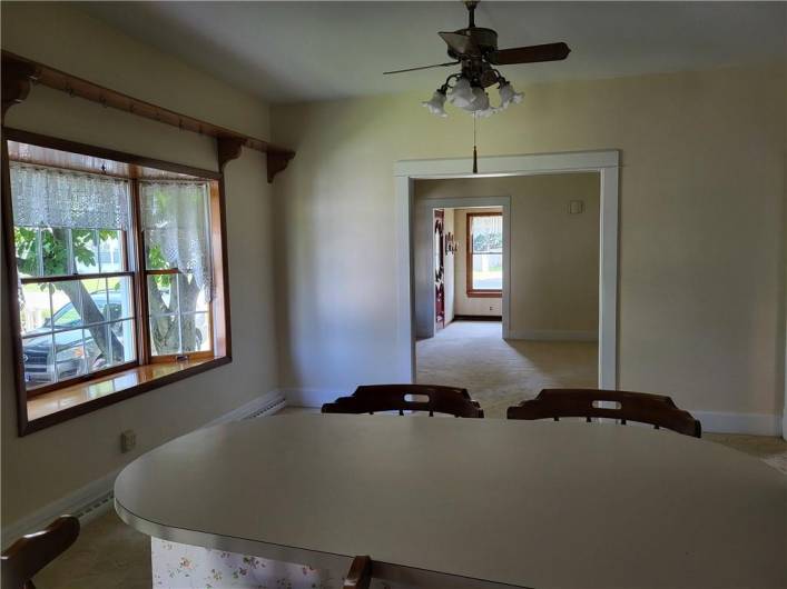 View is from the kitchen into the dining room, the living room, and the front entry is beyond that.