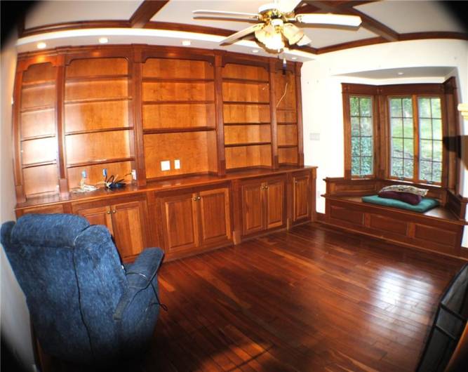 This family room is beautiful redwood with built in bookcases, window sits, newer windows, gas fireplace built in desk with shelves.  And Coffered Ceiling.