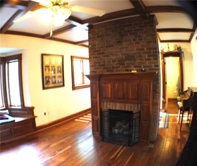 This family room is beautiful redwood with built in bookcases, window sits, newer windows, gas fireplace built in desk with shelves.  And Coffered Ceiling.