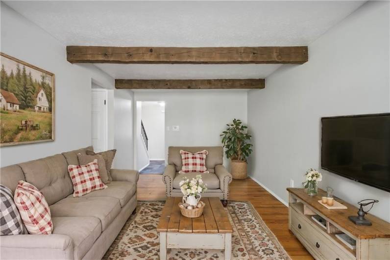 Family Room off of the entry also with hardwood floors. Virtually staged photo to illustrate what is possible!