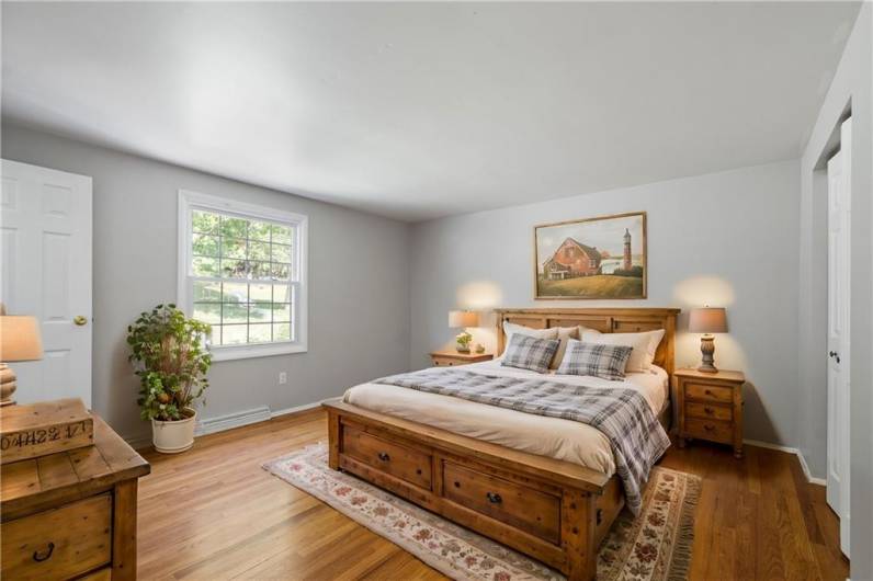 Primary Bedroom with double closets and private bath.Virtually staged photo to illustrate what is possible!