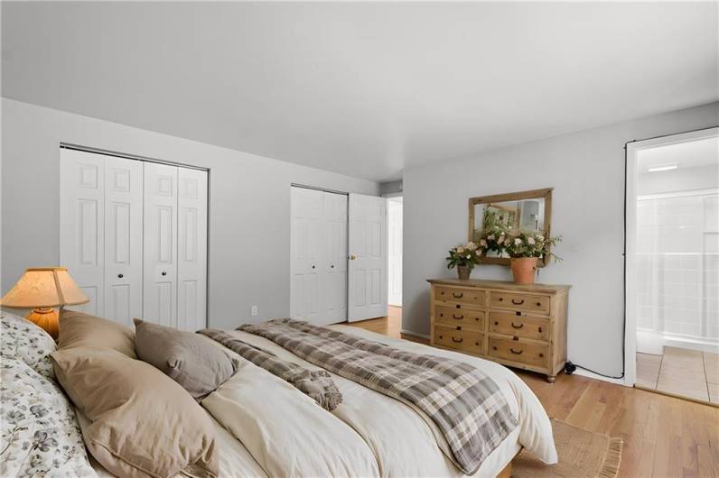 Primary Bedroom with double closets and private bath. Virtually staged photo to illustrate what is possible!