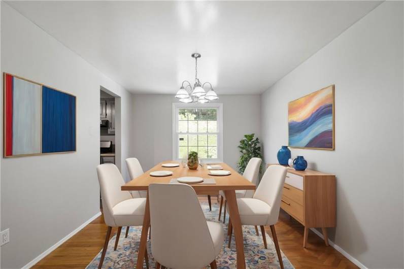 The hardwood floors flow right into the Dining Room.Virtually staged photo to illustrate what is possible!