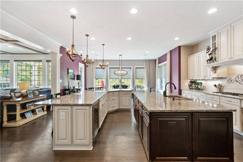 Custom lighting, tile backsplash, two-tone cabinets superb wood detail...