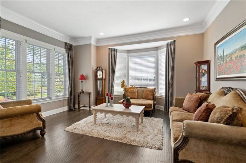 The formal living room is flooded with natural light