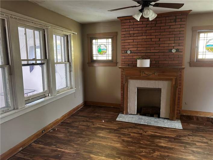 Living Room with decorative fireplace and stained glass windows