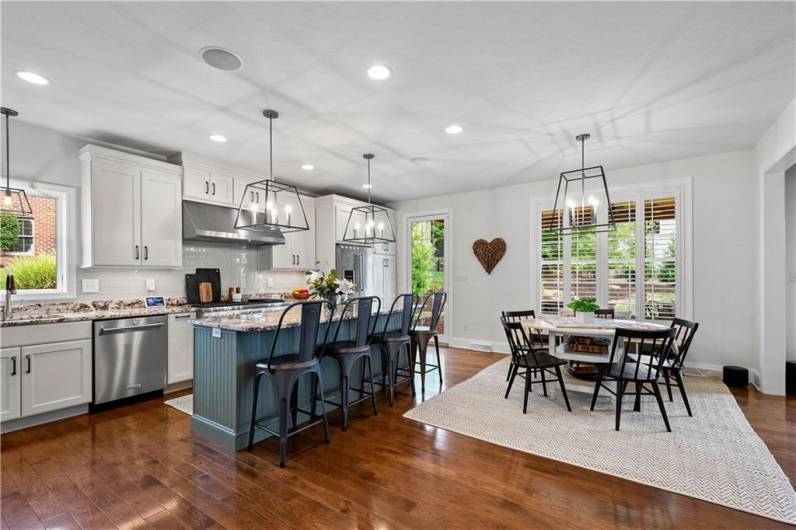 Open concept Eat-in Kitchen with island seating and high end appliances.