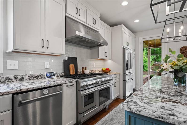 Gorgeous countertops paired with white tile backsplash.