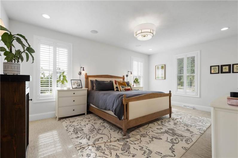 The main floor Primary Bedroom designed with high end Berber carpeting.