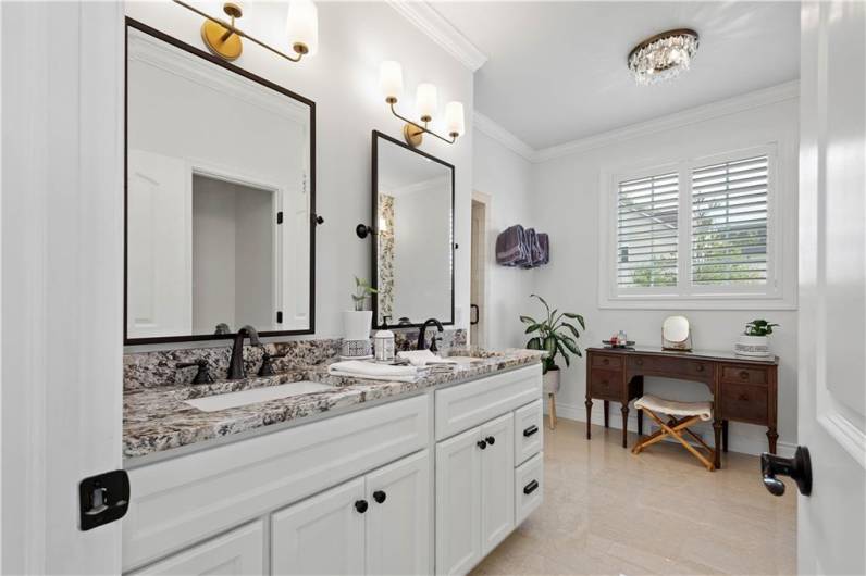 A Primary Bathroom that resembles a luxury hotel! Dual sink vanity, walk-in tile shower & a clawfoot soaking bathtub.