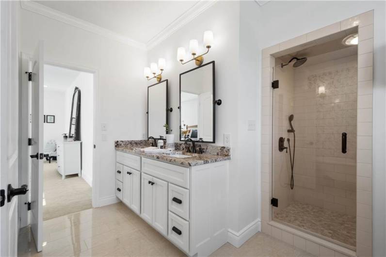 A Primary Bathroom that resembles a luxury hotel! Dual sink vanity, walk-in tile shower & a clawfoot soaking bathtub.