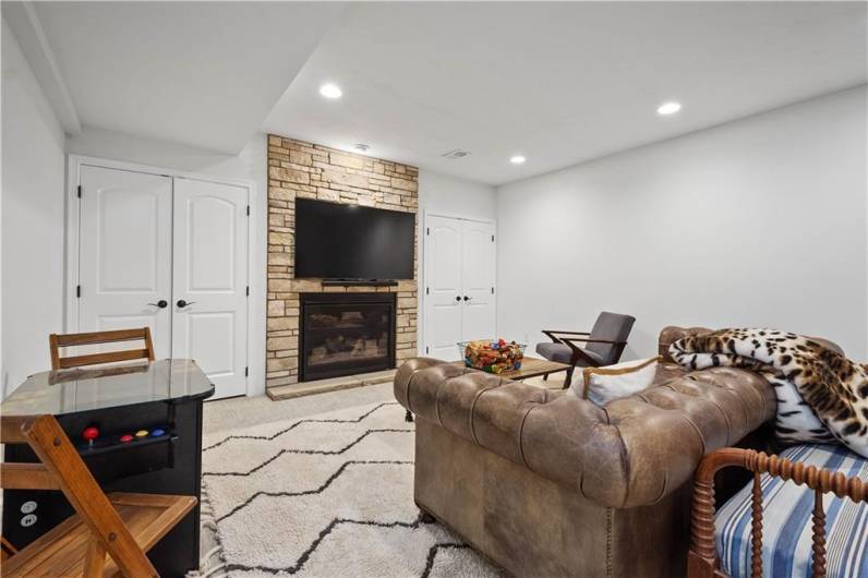 Cozy Game Room with stone gas fireplace.