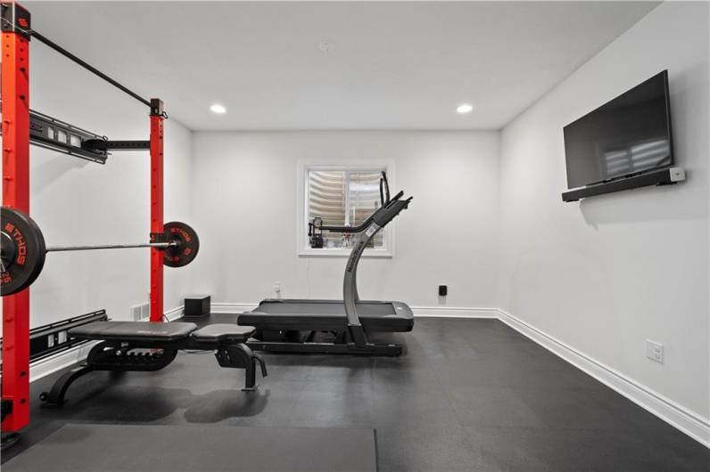 Custom gym rubber flooring. This room could also be a 5th bedroom.