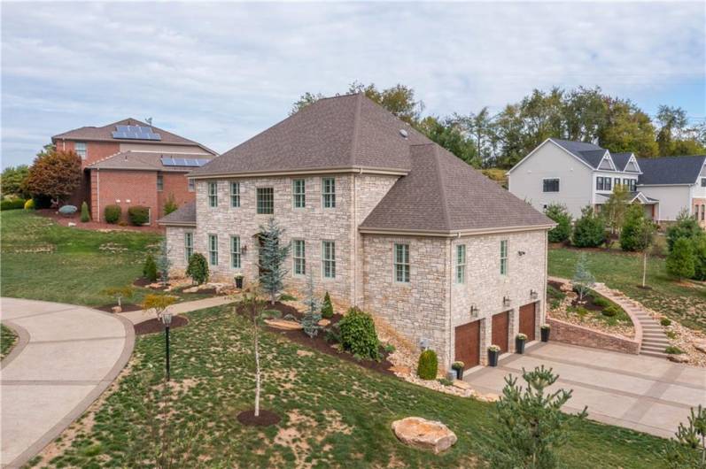 All Indiana Limestone exterior, 3 car garage, extra wide/long drieveway, corner lot.