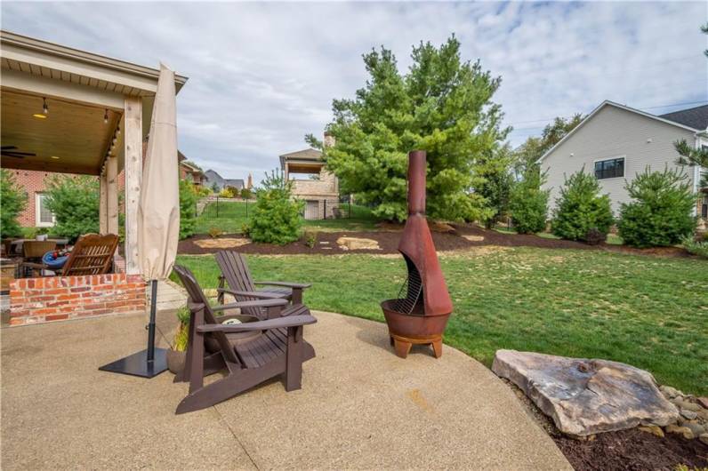 Fire Pit area and yard with privacy landscaping.