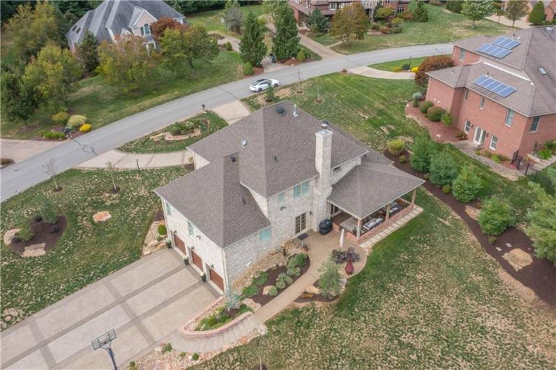 Aerial view of the property showing the landscape, front Govenor's driveway and large side driveway.