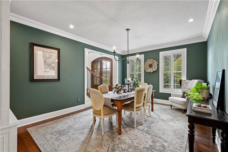 Beautiful Dining Room for hosting Friends & Family, with a unique chandelier and custom accent wood wall feature.