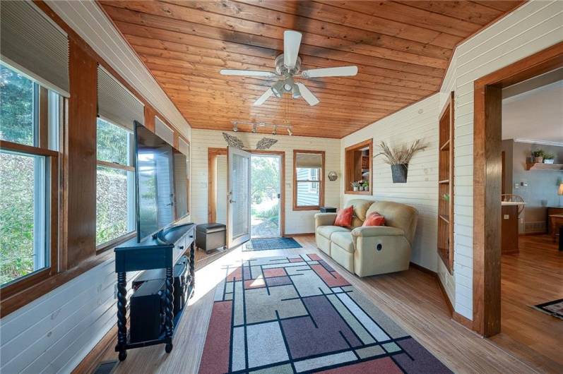 Light & bright sun room has a french door leading to the patio.