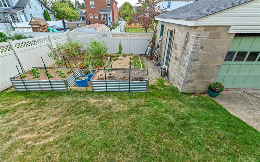 White no maintenance Privacy Fence surrounds your Yard with Raised Beds