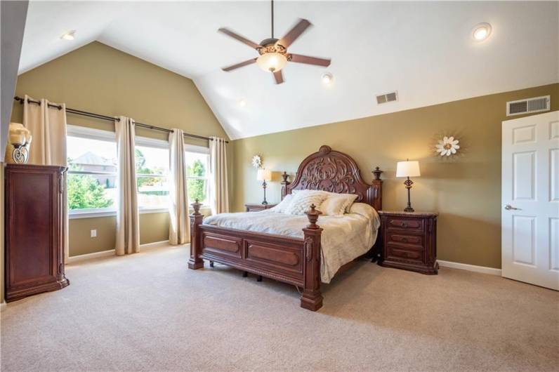 The primary bedroom is lovely size and boasts views of the rear yard and pool area.