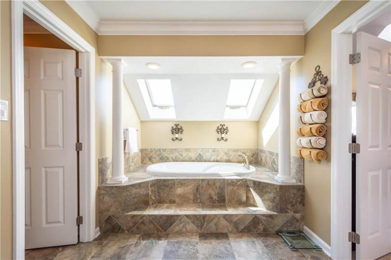 The primary bath has a whirlpool tub and oversized walk-in shower complete with body jets.