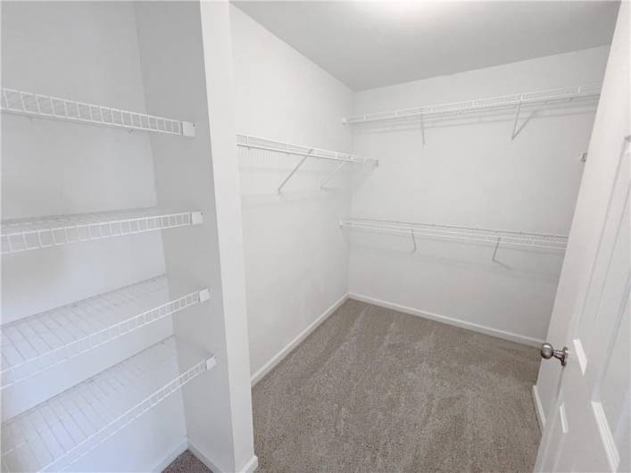 Walk-in closet in the primary bedroom.