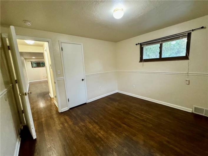 Front facing bedroom with hardwood floor