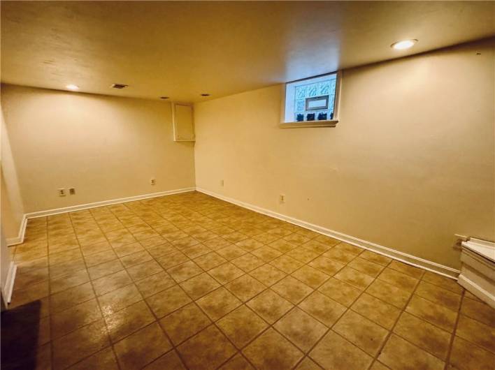 Lower level game room has tile floor