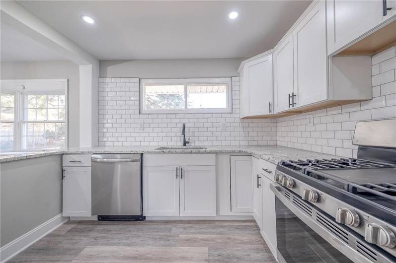 KITCHEN WITH NATURAL LIGHT FACING THE BACK YARD. APPROX. 19'X11'.