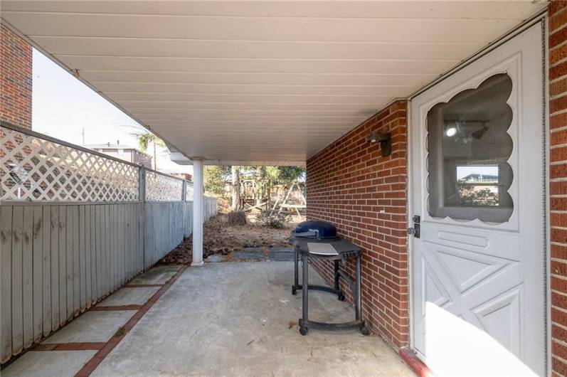 SIDE PATIO WITH DOOR OFF OF THE DINING ROOM. APPROX. SIZE 24'X10'.