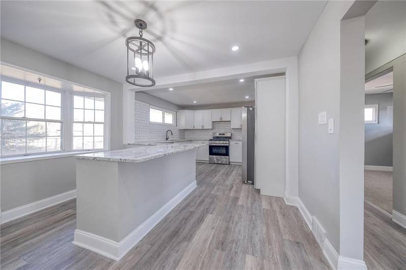 KITCHEN WITH GRANITE COUNTERTOPS AND STAINLESS STEEL APPLIANCES. PLENTY OF CABINETS AND COUNTER SPACE. APPROX. SIZE 19'X11'.