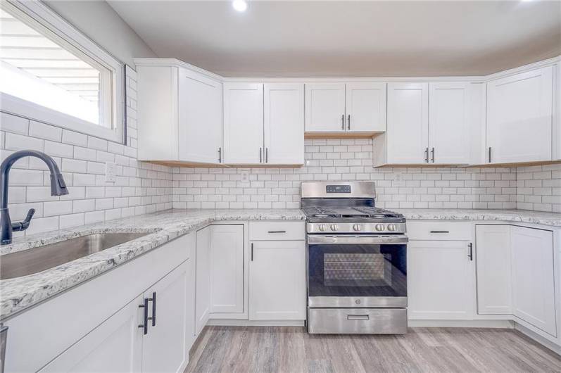 KITCHEN WITH STAINLESS STEEL APPLIANCES AND PLENTY OF COUNTER AND CABINET SPACE. APPROX. SIZE 19'X11'.