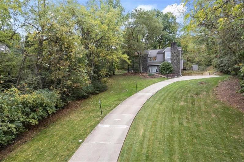 Nestled atop a serene 1.07-acre lot at the end of a peaceful cul-de-sac, this home offers unparalleled privacy. A long, sweeping driveway creates a dramatic entrance, enhancing the sense of seclusion and grandeur as you approach the property.