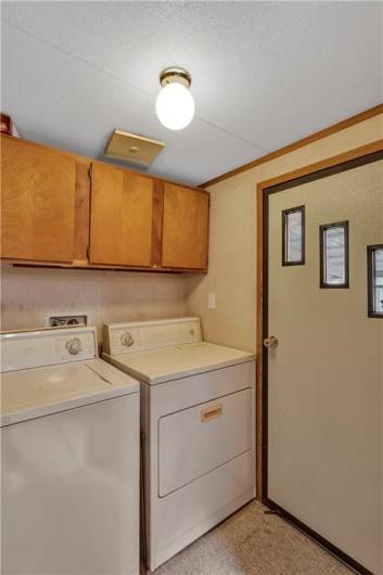 Laundry area and rear patio access point.  The washer and dryer are included.