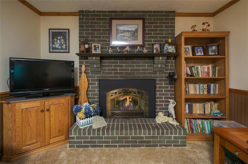 Brick faced, gas log fireplace with insert