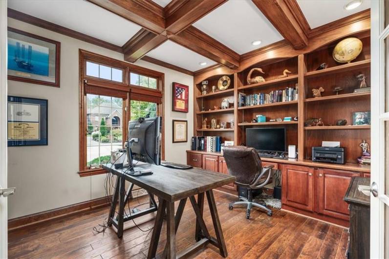 Frech doors lead to this executive office space with coffered ceilings, custom bookshelves, recessed lighting, transom window and hand scrapped engineered wood flooring.