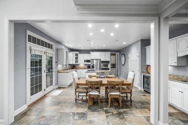 Light and bright open kitchen with beverage bar area including chiller and ice maker.