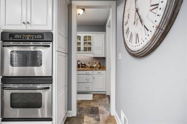 Just beyond the kitchen is the butlers pantry next too the door to the dining room.