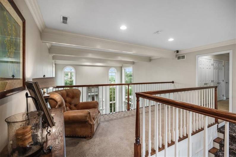 Upper hallway with overlook to the great room and front entry.