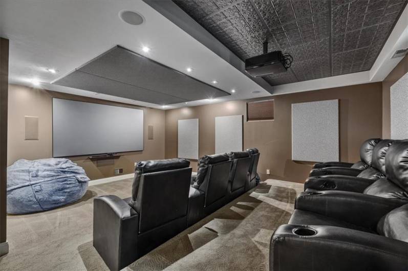 Theater room in lower level with tiered seating.