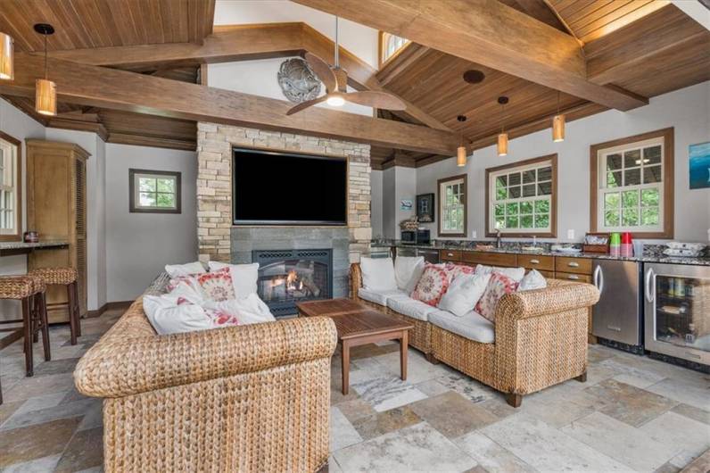 What a great space to entertain!  Volcanic rock Fireplace, beverage frig, chiller drawers, tile flooring, ceiling fan and more.