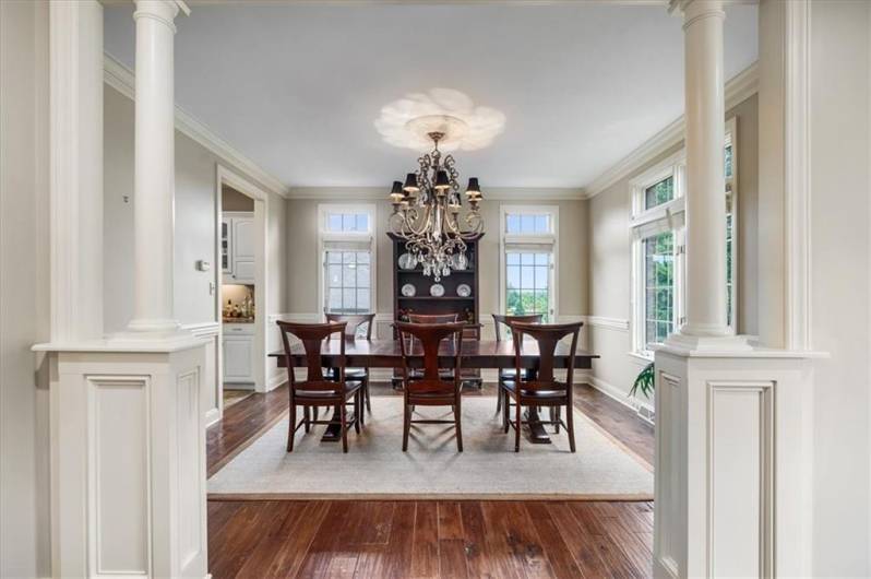 What a bold statement with pillared entry,  crown molding and elegant chandelier.