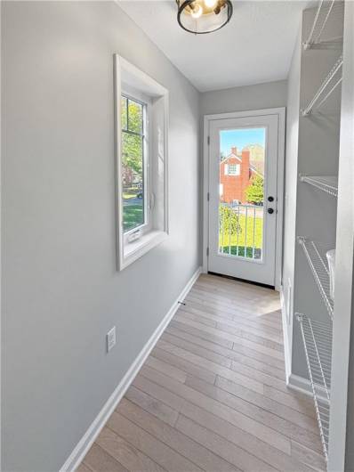 Hallway with pantry storage and door to the future deck.