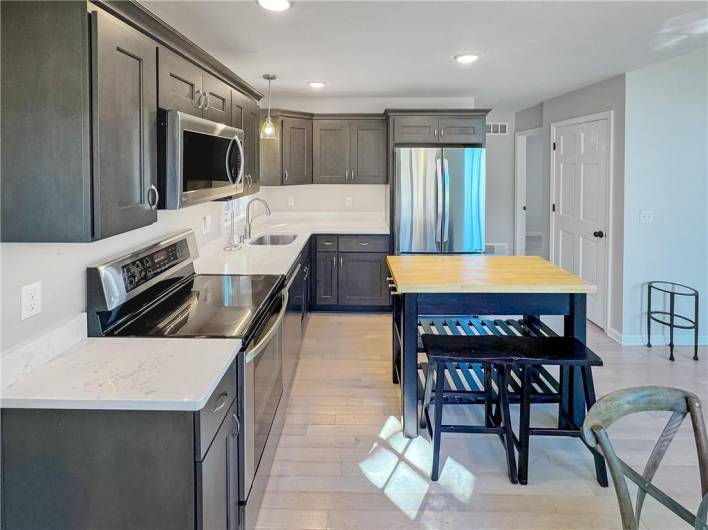 Gorgeous kitchen with granite counter tops, stainless steel appliances and recessed lighting.