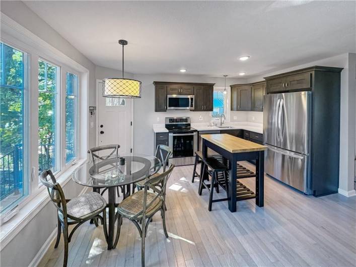 Dining area near kitchen.  The moveable island and stools will stay.