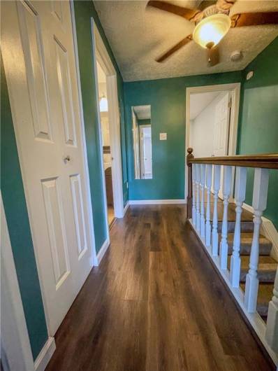 The upstairs hallway has updated vinyl flooring.