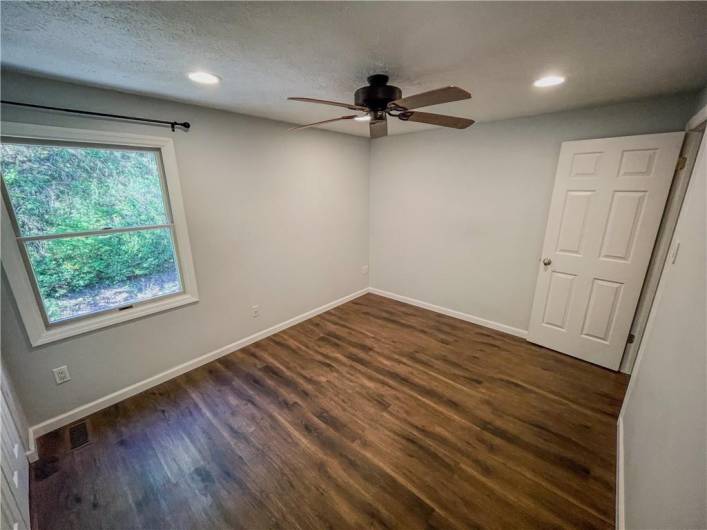 A large window provides a view to a private area in the back of the home.